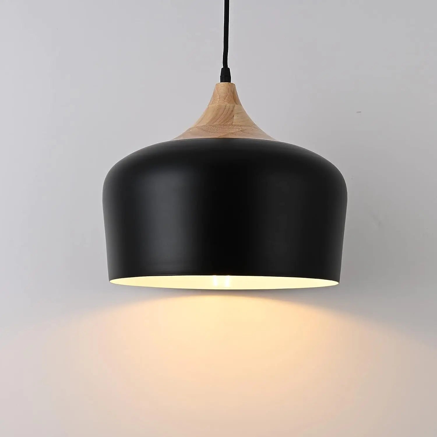 Scandinavian wood pendant light over a white table