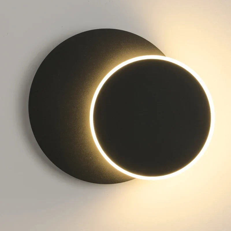 Eclipse LED wall light behind a sofa