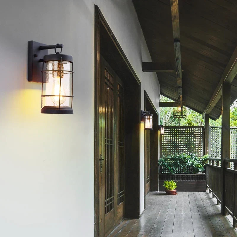 Black wall light in a garden