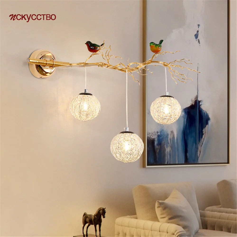 Bird nest wall light above a sofa