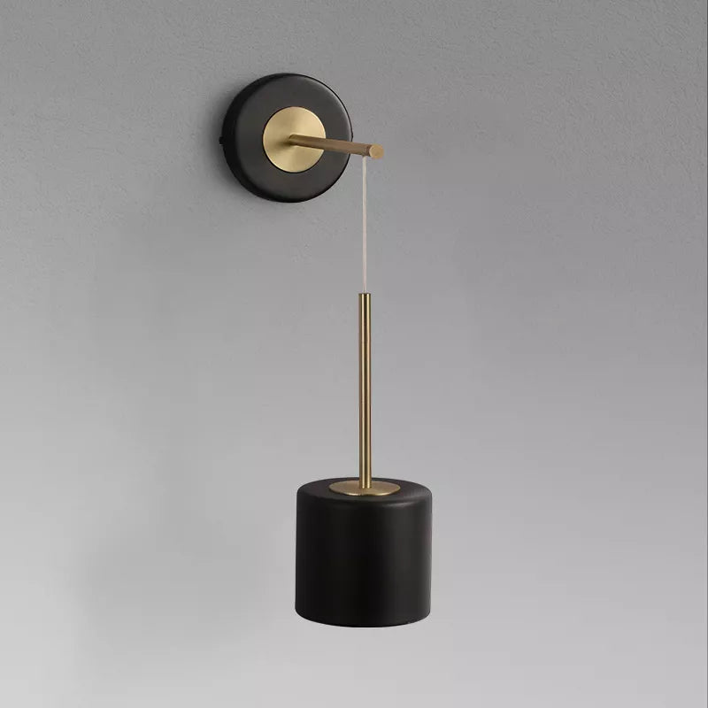 Hanging wall light by a bed