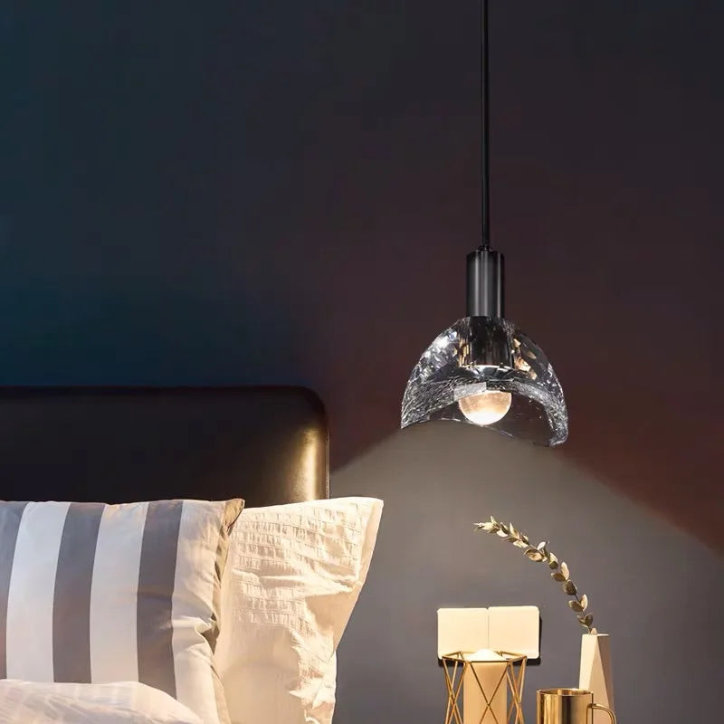 Gold crystal pendant by a bed