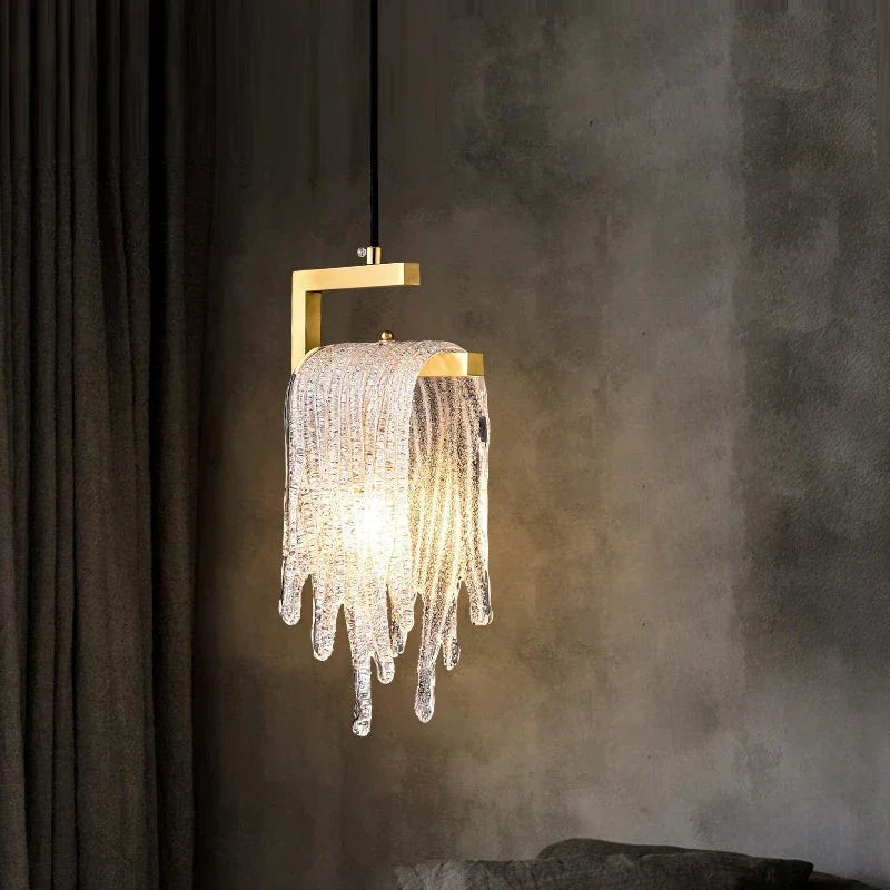 Gold glass pendant by a bed