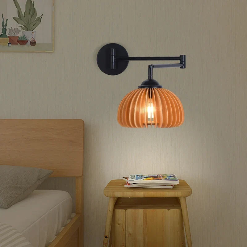 Wood swing arm sconce by a bed