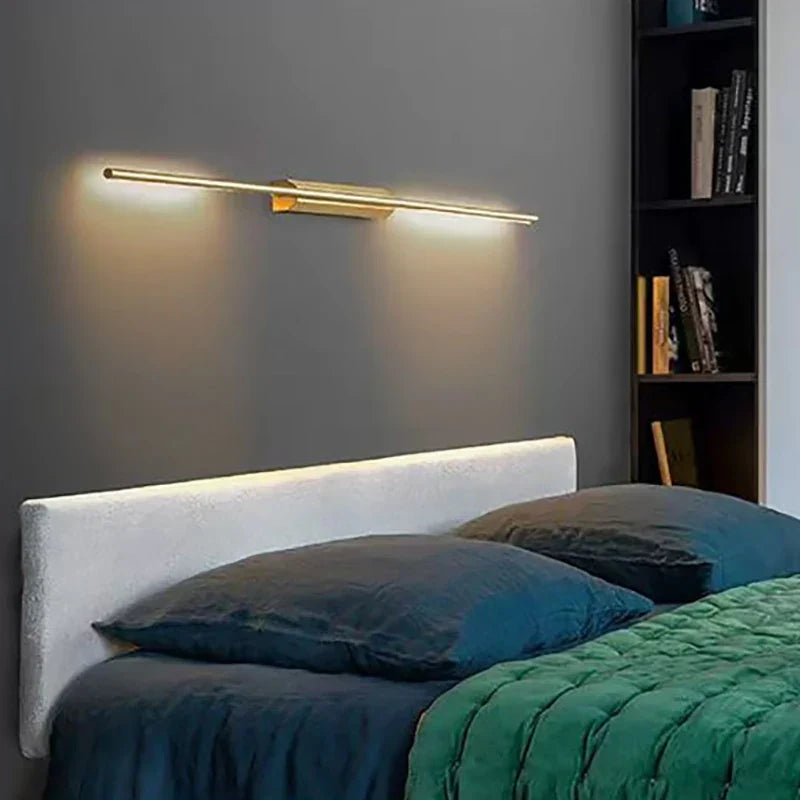 Long gold wall light above a sofa
