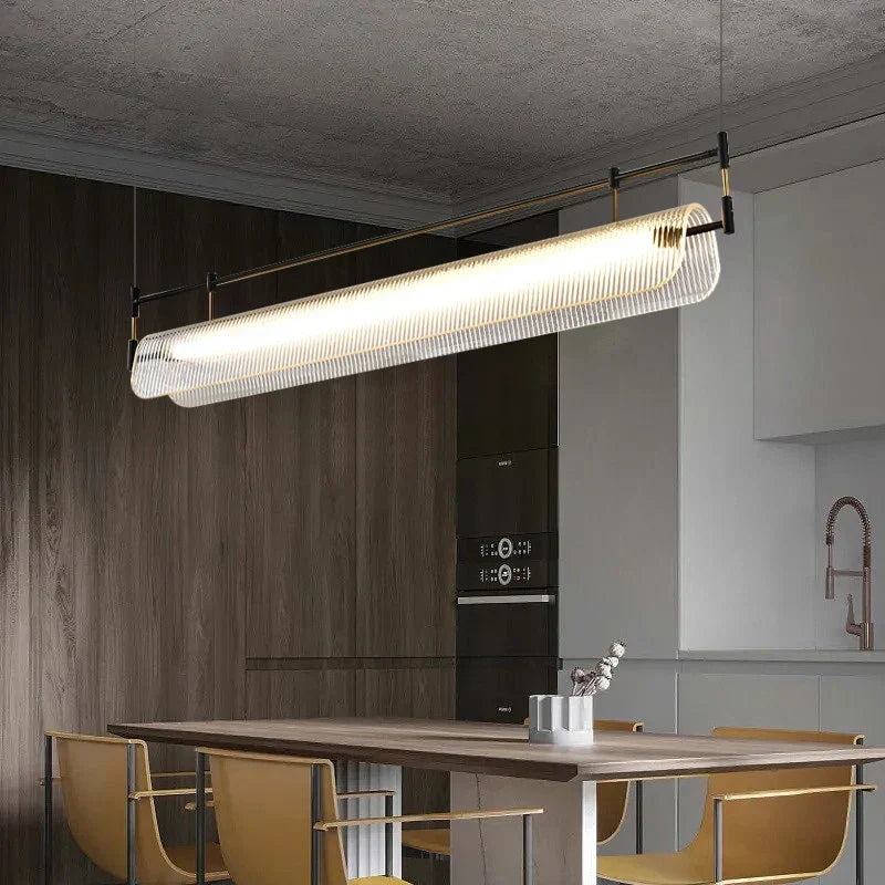 Gold linear pendant over a dining table