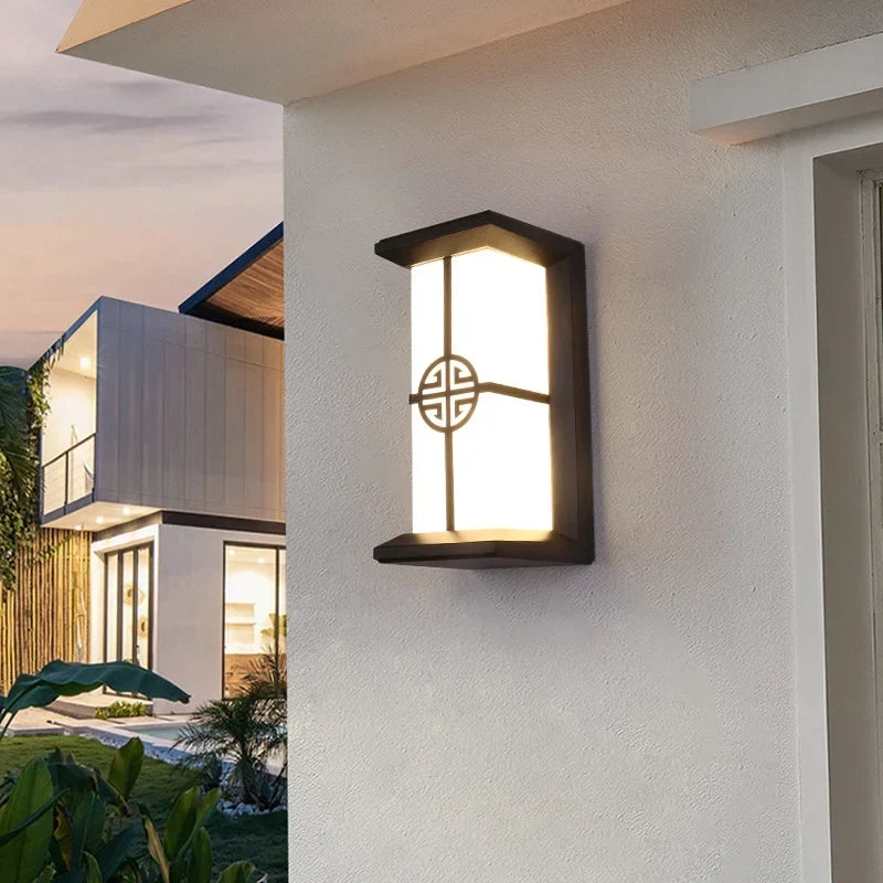 Silver garden wall light on a patio