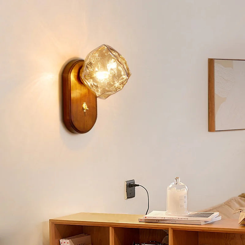 Amber glass sconce beside a bed