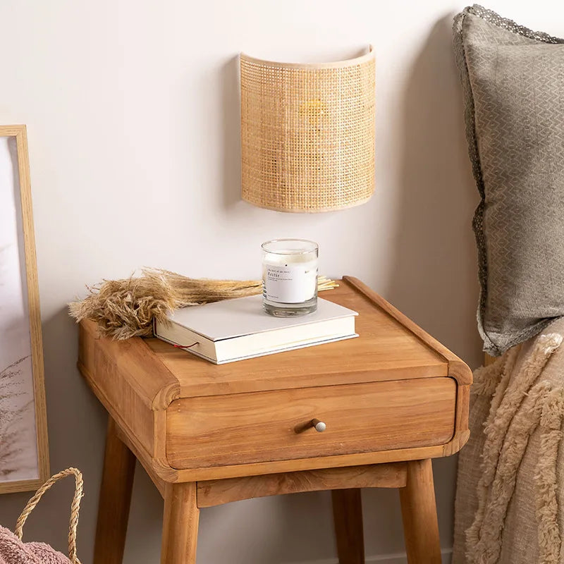 Woven rattan sconce beside a bed