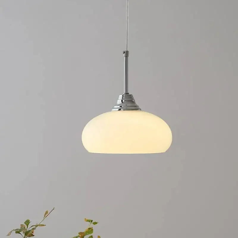 Copper and cream pendant over a kitchen island