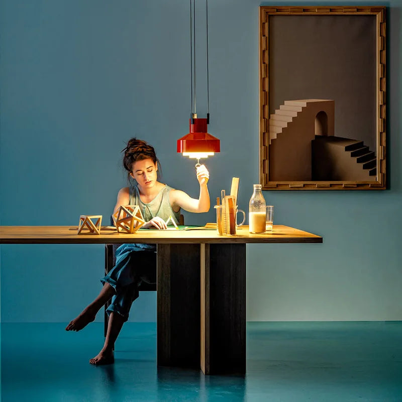 Red adjustable pendant over a kitchen table
