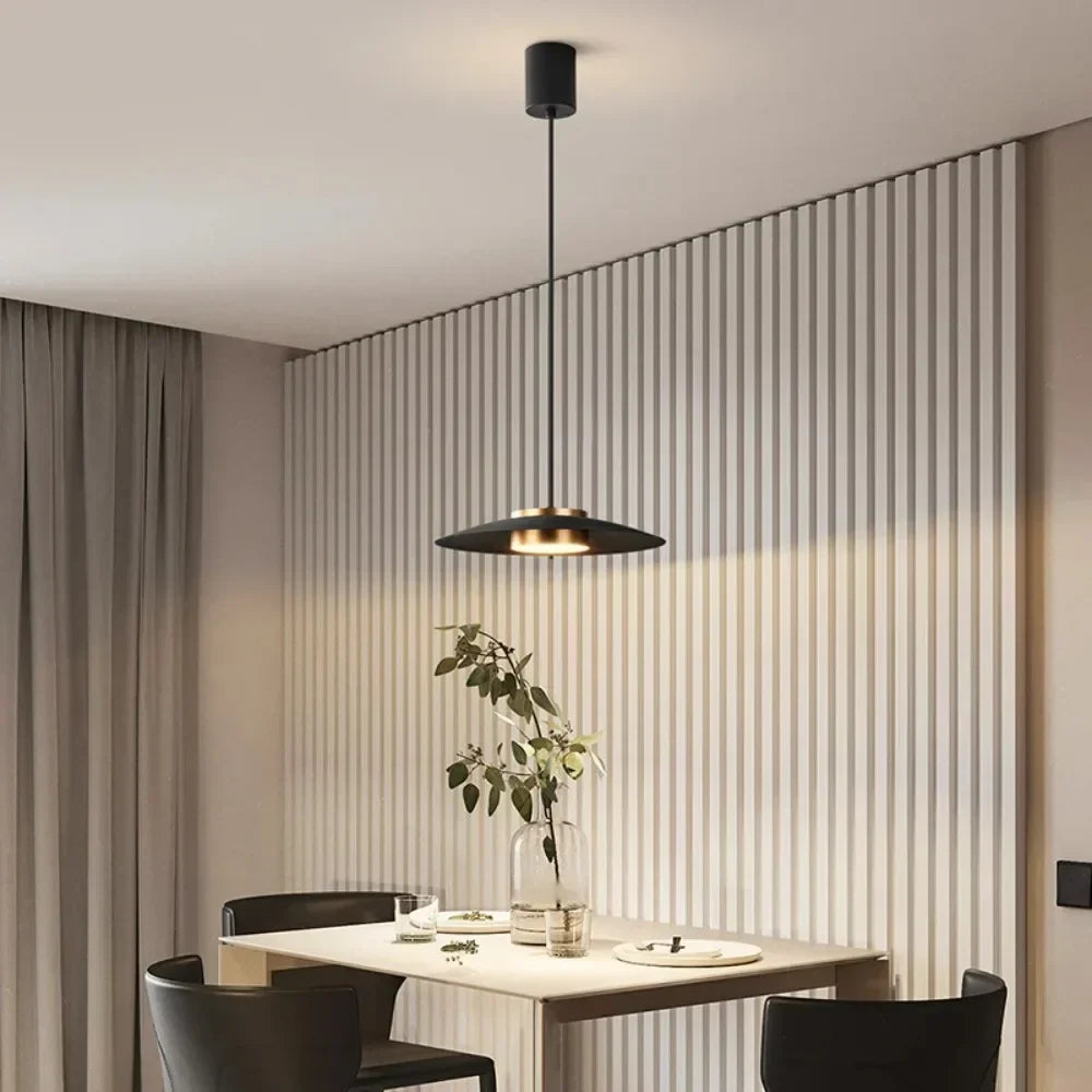 White LED pendant beside a bed