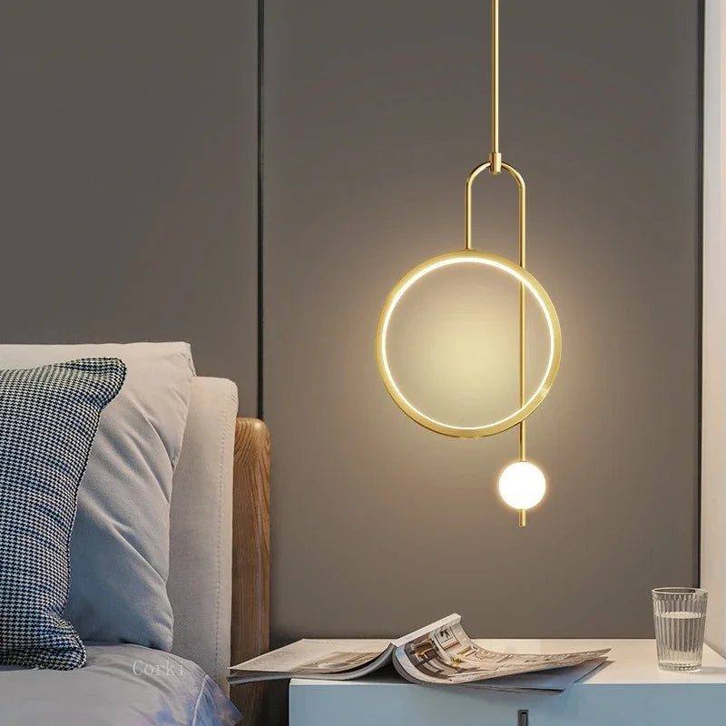 Pair of ring pendants by a bed