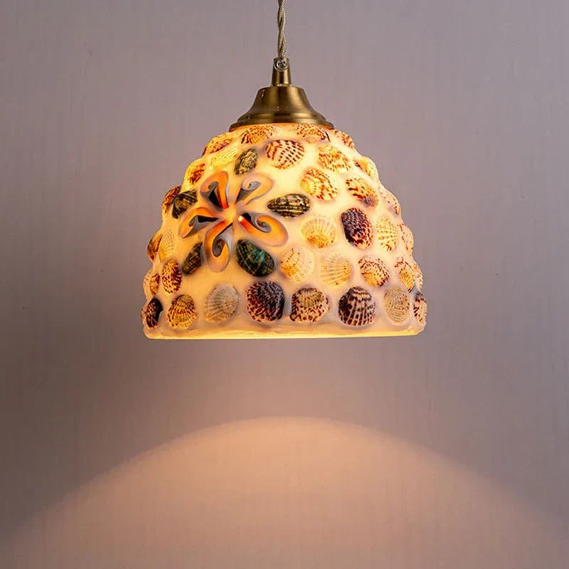 Shell pendant in a coastal bedroom