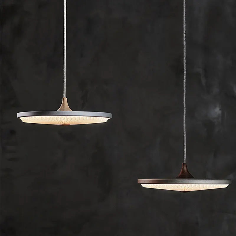 Gray pleated pendant over a bar