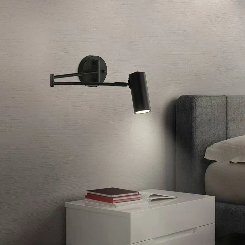 Gold reading wall light by a bed