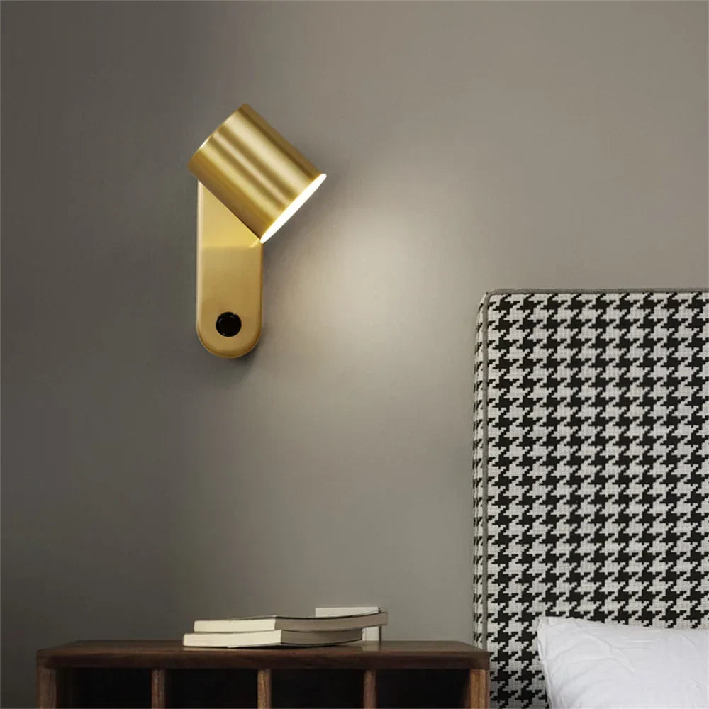 Brass reading sconce beside a bed