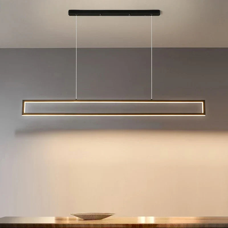 Black rectangular pendant over a dining table