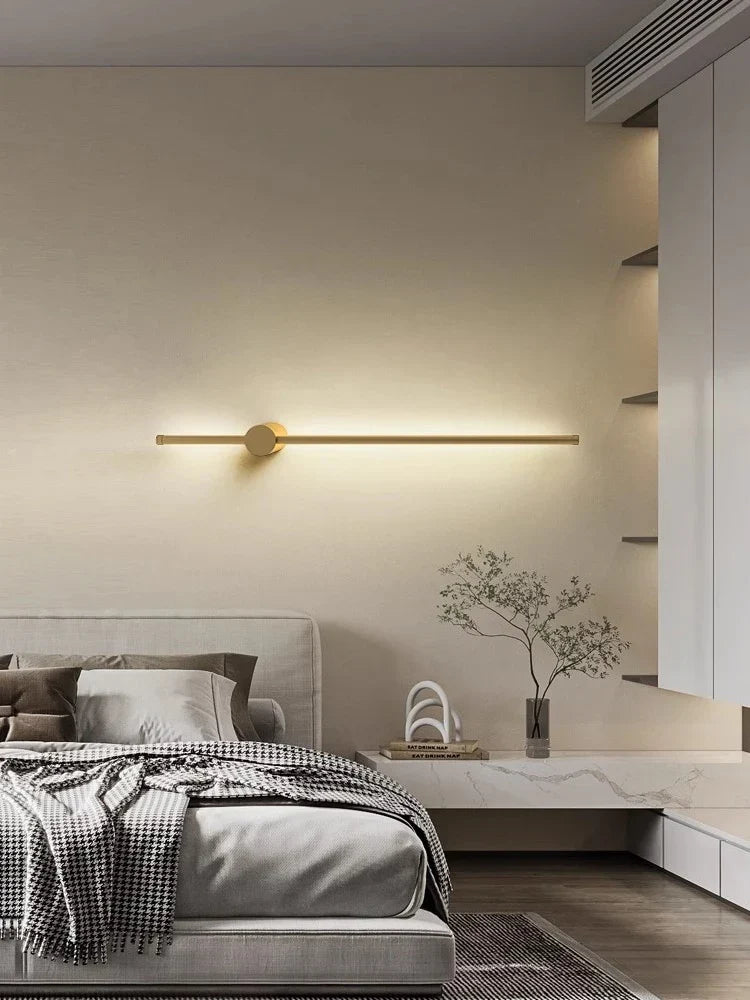 Black linear wall light above a sofa