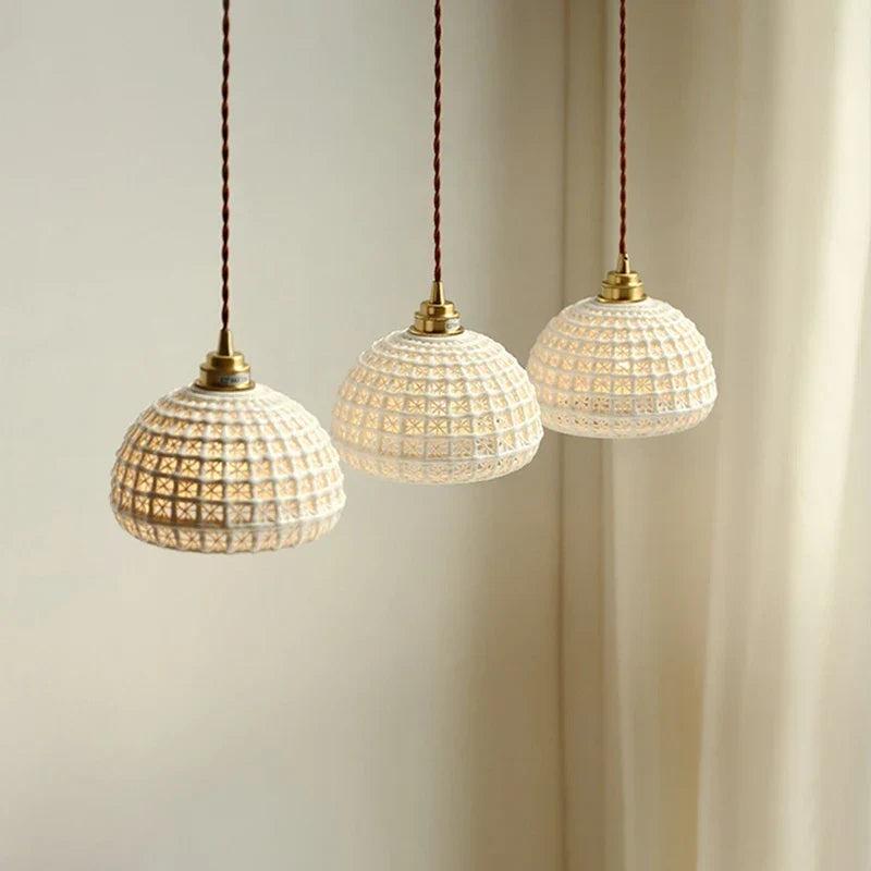 Ceramic pendant by a bed