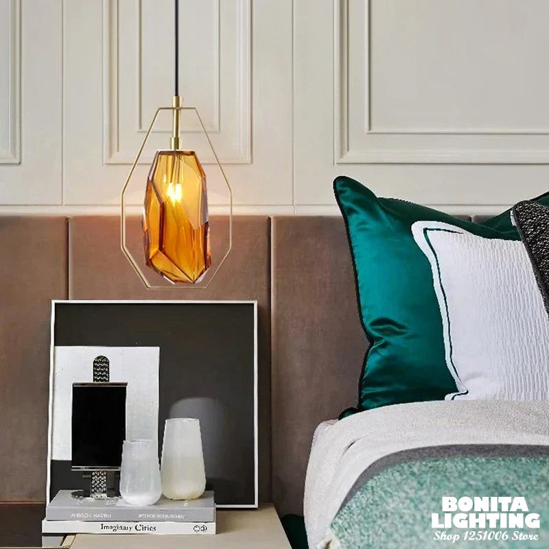 Gray glass pendant beside a bed