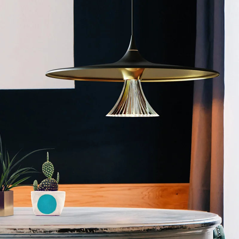White saucer pendant over a dining table