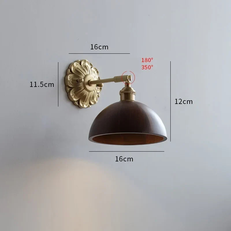 Walnut wall light by a bed