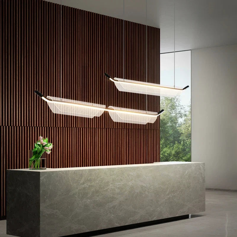 Gold linear pendant over a bar
