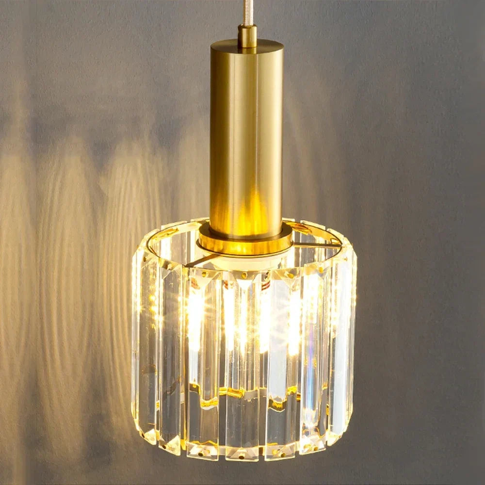 Gold crystal pendant beside a bed