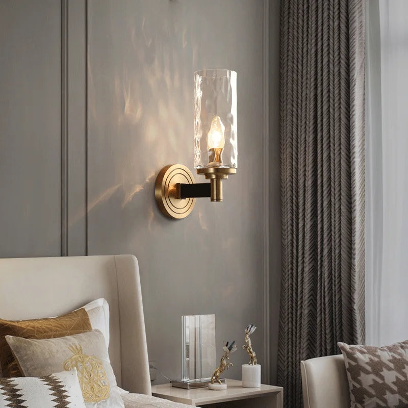 Ripple glass sconce beside a bed