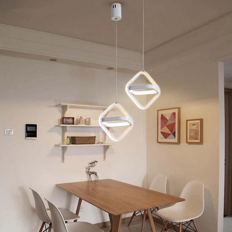 Black geometric pendant over a dining table