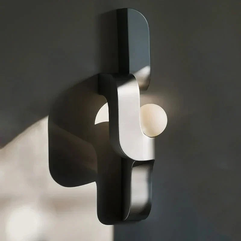 Geometric wall light behind a TV