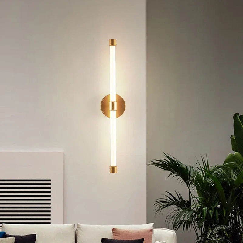 Gold postmodern wall light by a bed