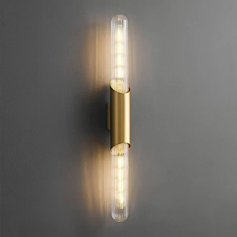 Brass sconce beside a mirror