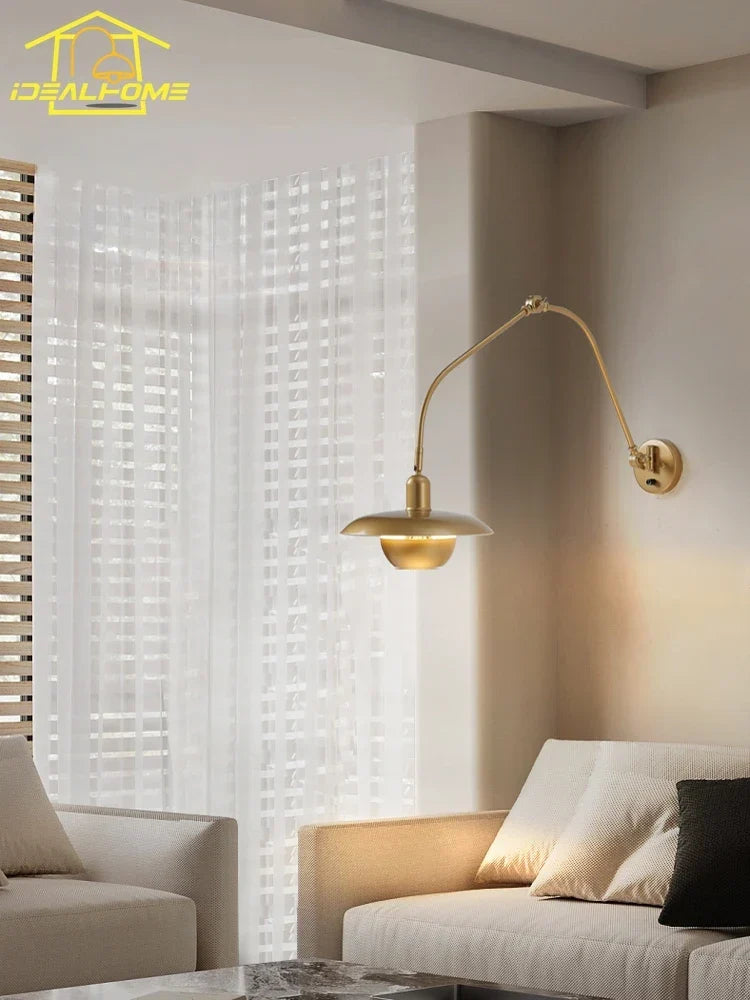 Gold swing arm sconce