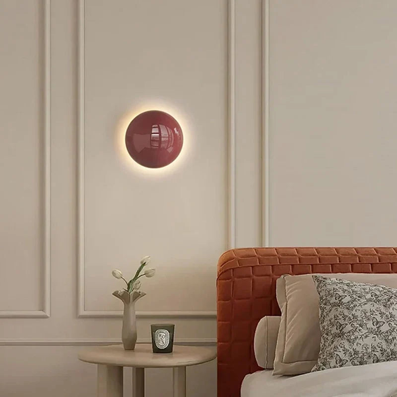 Red adjustable sconce by a bed