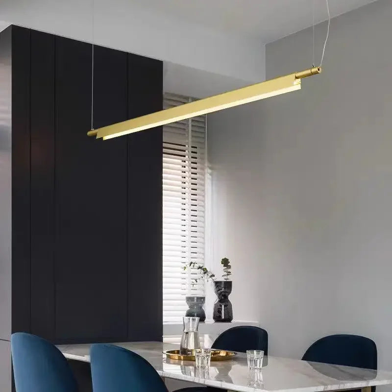 Gold linear pendant over a table