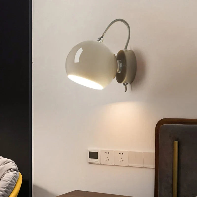 Beige magnetic sconce by a bed